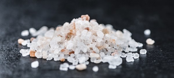 Pink Salt on a vintage background as detailed close-up shot (selective focus)