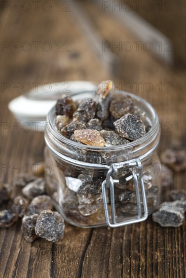 Brown Rock Candy on wooden background (selective focus, close-up shot)
