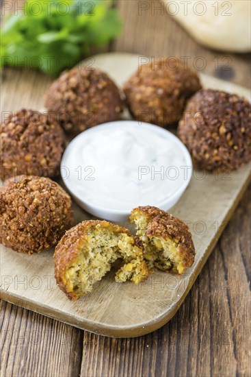 Portion of Falafel on an old wooden table (close-up shot, selective focus)