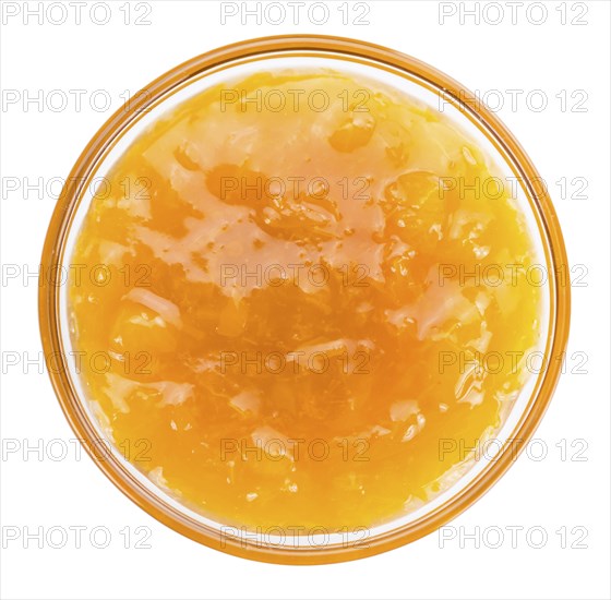 Apricot Jam isolated on white background (selective focus, close-up shot)