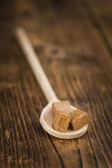 Caramel on a vintage background as detailed close-up shot (selective focus)