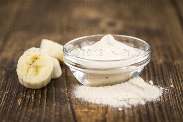 Banana Powder on rustic wooden background as close-up shot