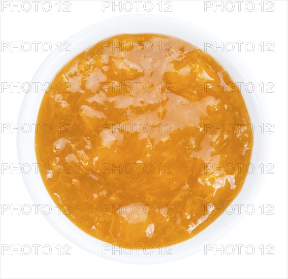 Apricot Jam isolated on white background (selective focus, close-up shot)