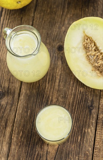 Healthy Honeydew Melon Smoothie (selective focus) on an old wooden table