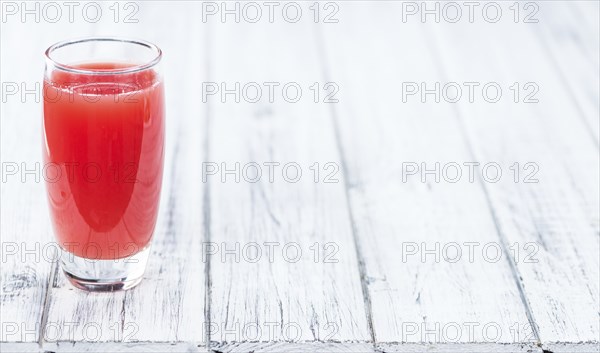 Homemade Watermelon Smoothie on an wooden table (selective focus) as detailed close-up shot