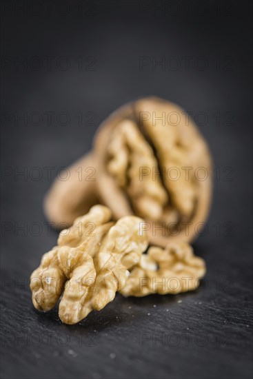 Walnut kernels on a vintage background as detailed close-up shot (selective focus)