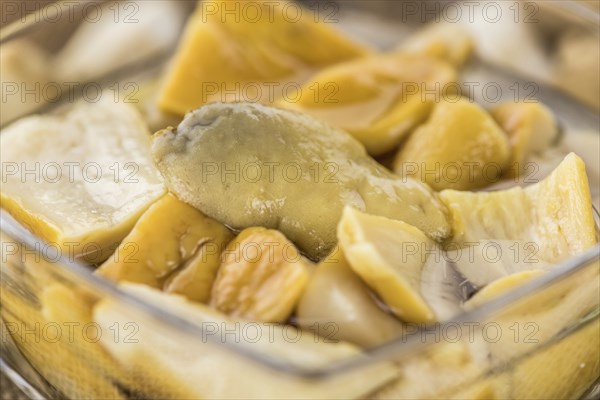 Homemade Preserved Porcinis on an wooden table as detailed close-up shot, selective focus