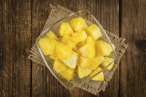 Fresh made Pineapple (sliced) on a vintage background as detailed close-up shot