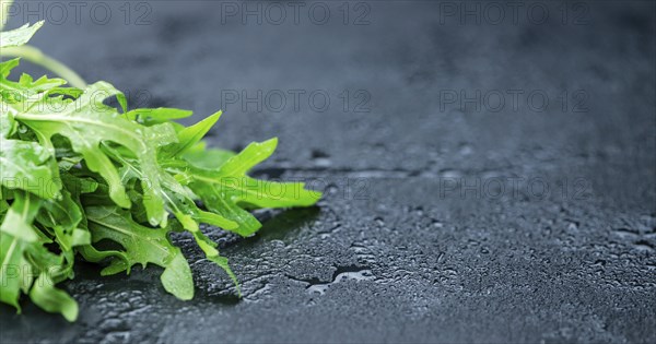 Portion of fresh Arugula (detailed close-up shot, selective focus)