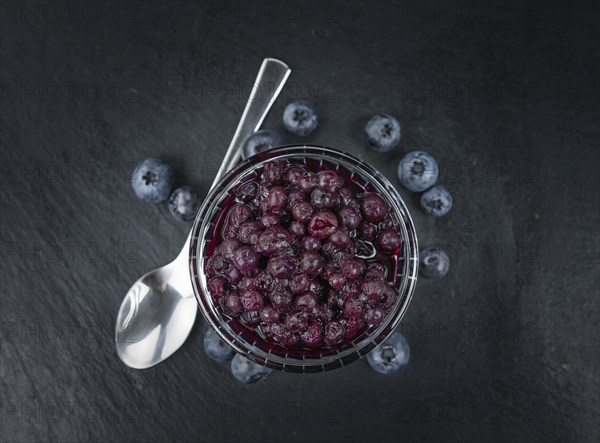 Canned Blueberries on a vintage slate slab as detailed close-up shot, selective focus