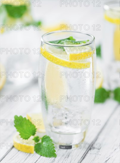 Homemade Lemonade on vintage background (selective focus, close-up shot)