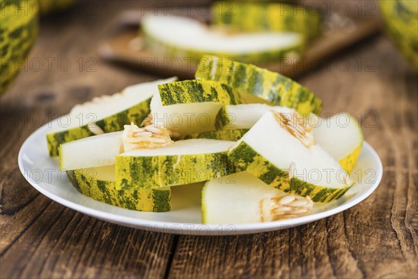 Futuro Melons on an old wooden table as detailed close-up shot (selective focus)