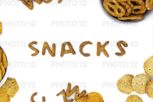 Portion of mixed Snacks isolated on white background (detailed close up shot, selective focus)