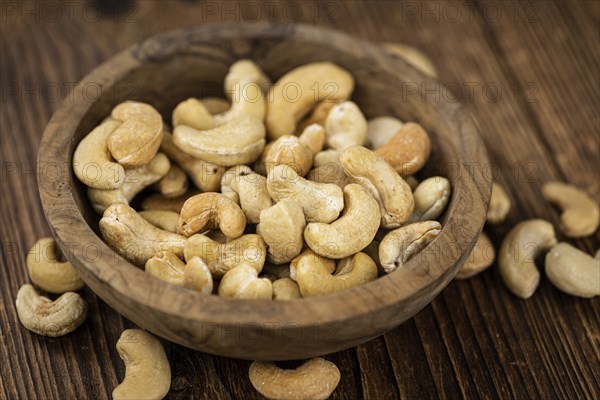 Some roasted Cashew Nuts as detailed close up shot (selective focus)
