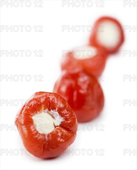 Filled Pimientos isolated on white background (selective focus, close-up shot)