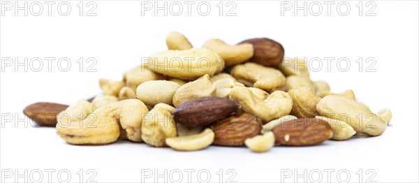 Fresh roasted nuts isolated on white background as close up shot (selective focus)