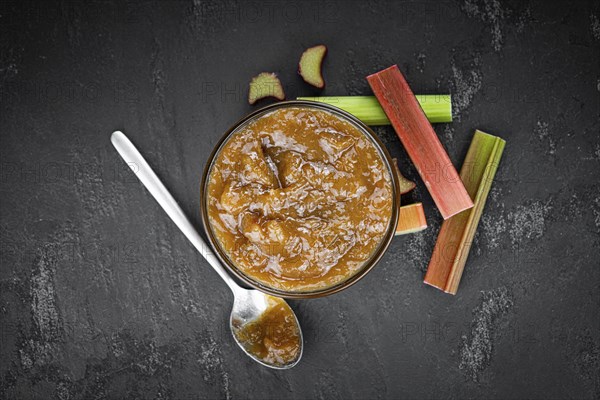 Homemade Rhubarb Jam on rustic background (close up shot, selective focus)