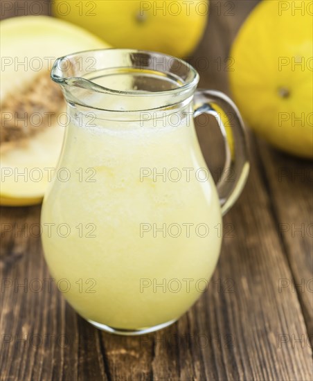 Homemade Honeydew Melon Smoothie on wooden background (selective focus)