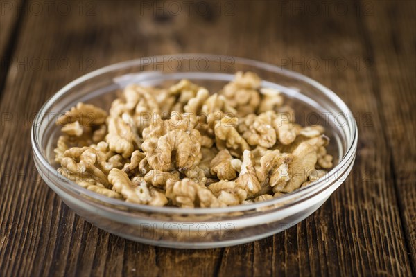 Walnut kernels on a vintage background as detailed close-up shot (selective focus)