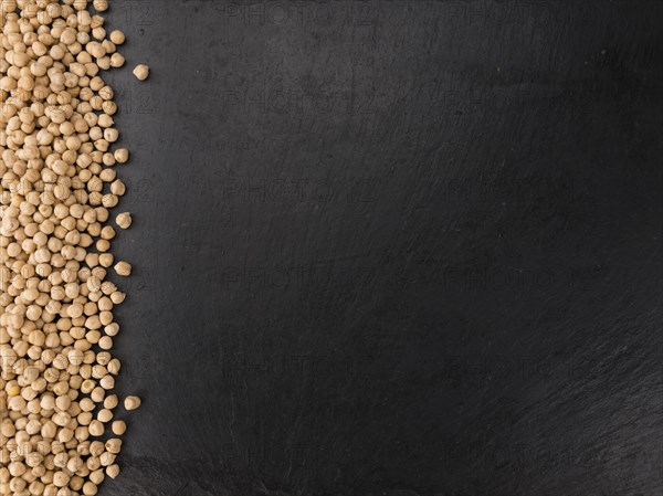 Portion of dried Chickpeas on a rustic slate slab, selective focus, close-up shot