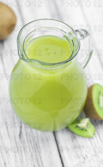 Kiwi Smoothie (selective focus) on an old and vintage background (homemade)