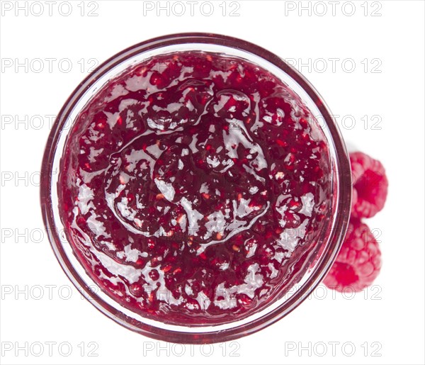 Fresh made Raspberry Jam isolated on white background, close-up shot