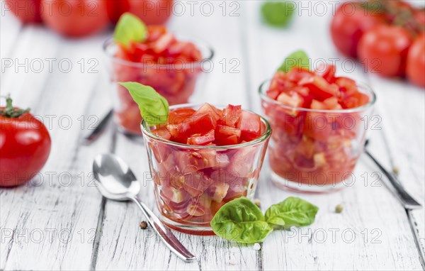 Homemade Cutted Tomatoes on vintage background (selective focus, close-up shot)