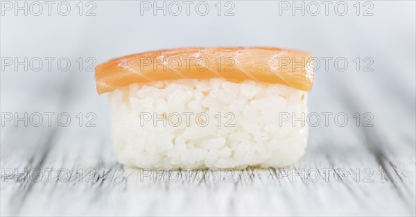 Portion of Sushi on a wooden table (selective focus, close-up shot)