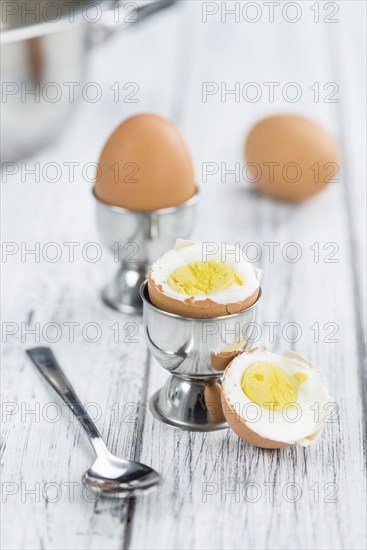 Some boiled Eggs (close-up shot, selective focus) on an old wooden table