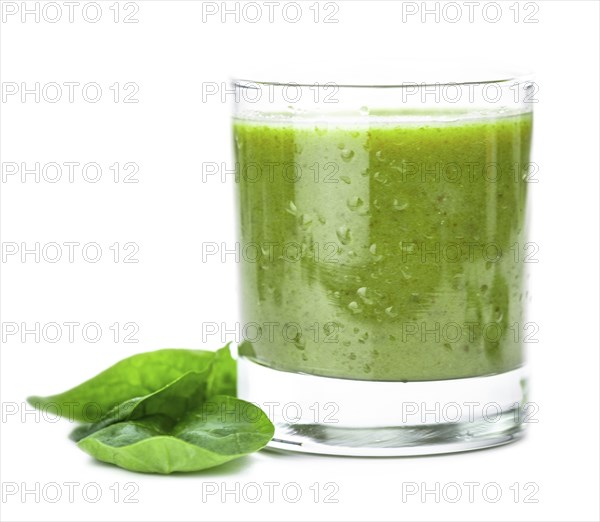 Homemade spinach smoothie isolated on white background (close up, selective focus)