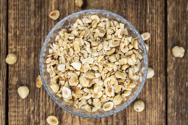 Freshly chopped Hazelnuts as detailed close up shot (selective focus)