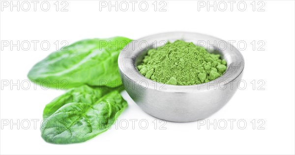 Spinach powder isolated on white background (close up, selective focus)