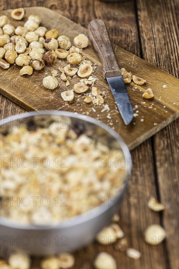 Freshly chopped Hazelnuts as detailed close up shot (selective focus)