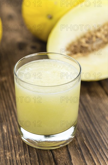 Homemade Honeydew Melon Smoothie on wooden background (selective focus)
