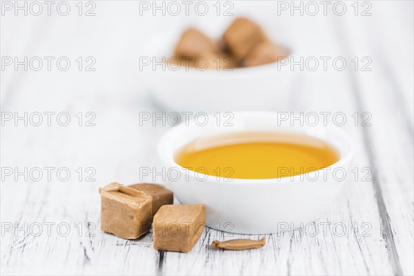 Portion of fresh Caramel Sirup (close-up shot, selective focus)