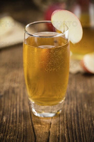 Fresh made Apple Cider on a vintage background (close-up shot)