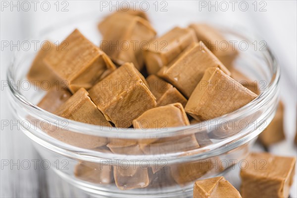 Caramel on a vintage background as detailed close-up shot (selective focus)