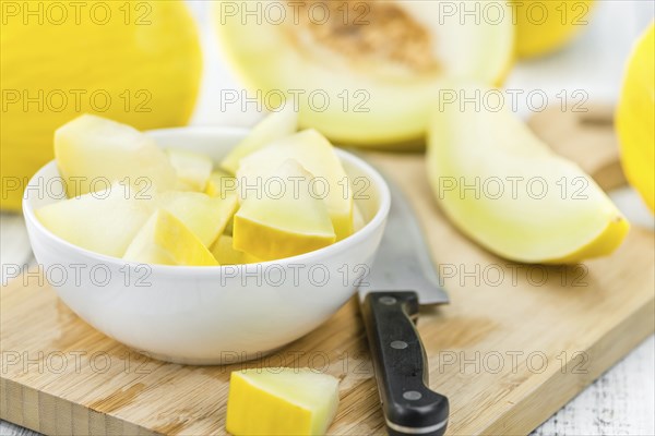 Honeydew Melon on an old wooden table as detailed close-up shot (selective focus)