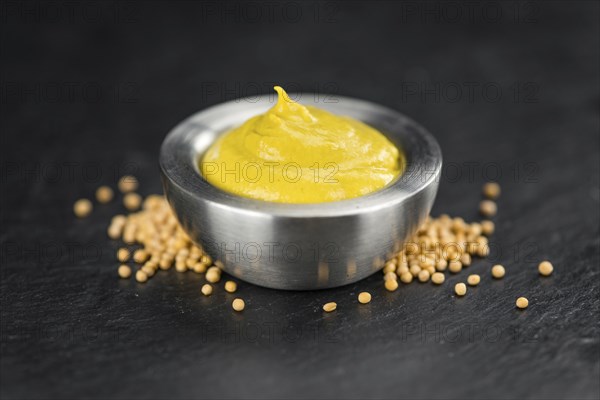 Mustard on a vintage background as detailed close-up shot (selective focus)