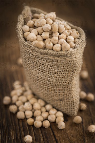 Chickpeas on a vintage background as detailed close-up shot, selective focus
