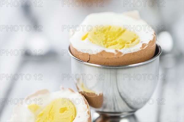 Some boiled Eggs (close-up shot, selective focus) on an old wooden table