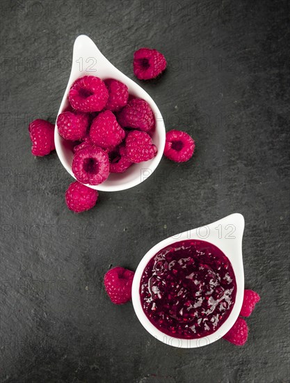 Fresh made Raspberry Jam on a vintage background as detailed close-up shot