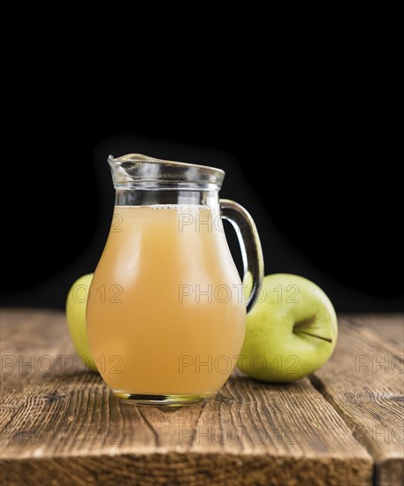 Apple Juice on a vintage background as detailed close-up shot (selective focus)
