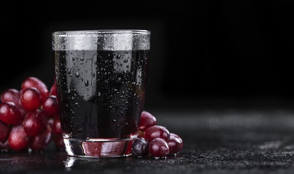 Some fresh Red Grape Juice (selective focus, close-up shot)