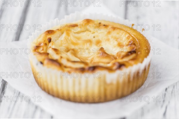 Fresh made Mini Cheesecake on an old and rustic wooden table (selective focus, close-up shot)