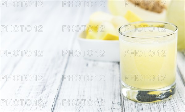 Honeydew Melon smoothie (close-up shot, selective focus) on a wooden table