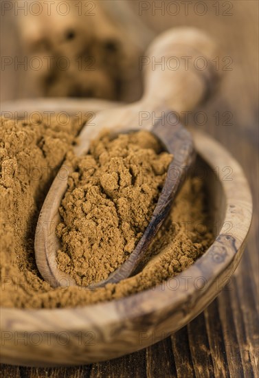 Fresh made Cinnamon Powder on a vintage background (close-up shot)