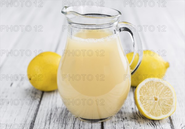 Fresh made Juice (lemon) on a vintage background (close-up shot)