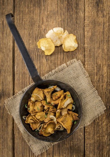 Portion of fresh Fried Chanterelles close-up shot, selective focus