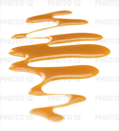 Caramel Sauce on a vintage slate slab (close-up shot, selective focus)